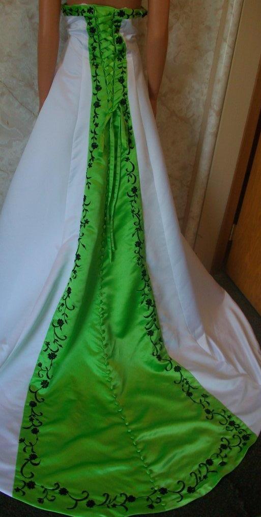 white dress with green trim and black embroidery