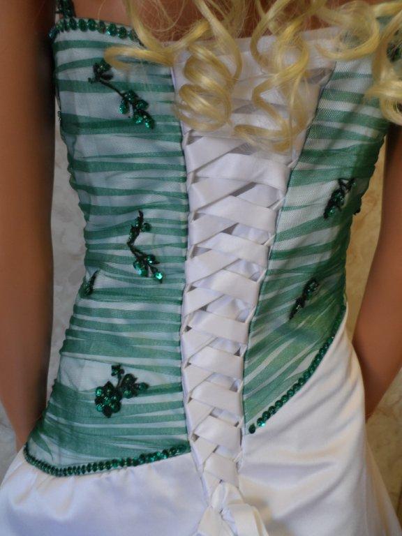 white lace up corset highlights the emerald green