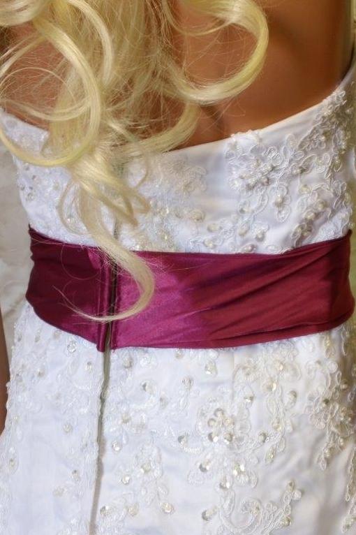 white wedding gown with fuschia sash