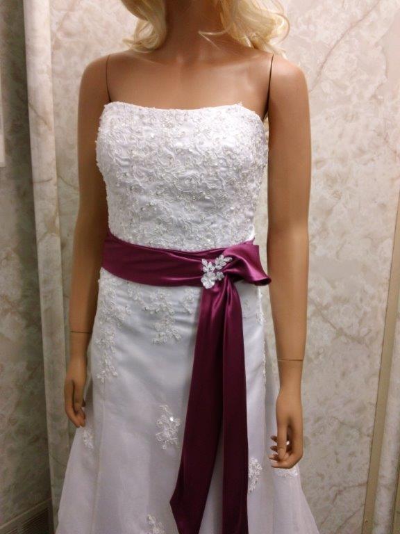 white lace wedding gown with fuschia sash