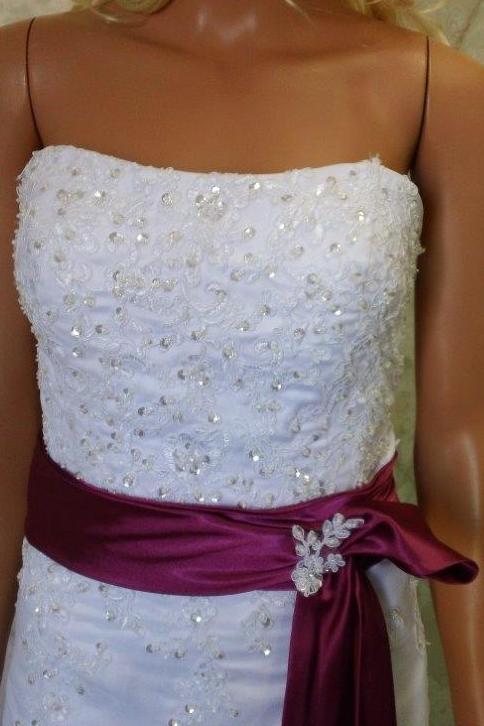 white wedding gown with fuschia sash