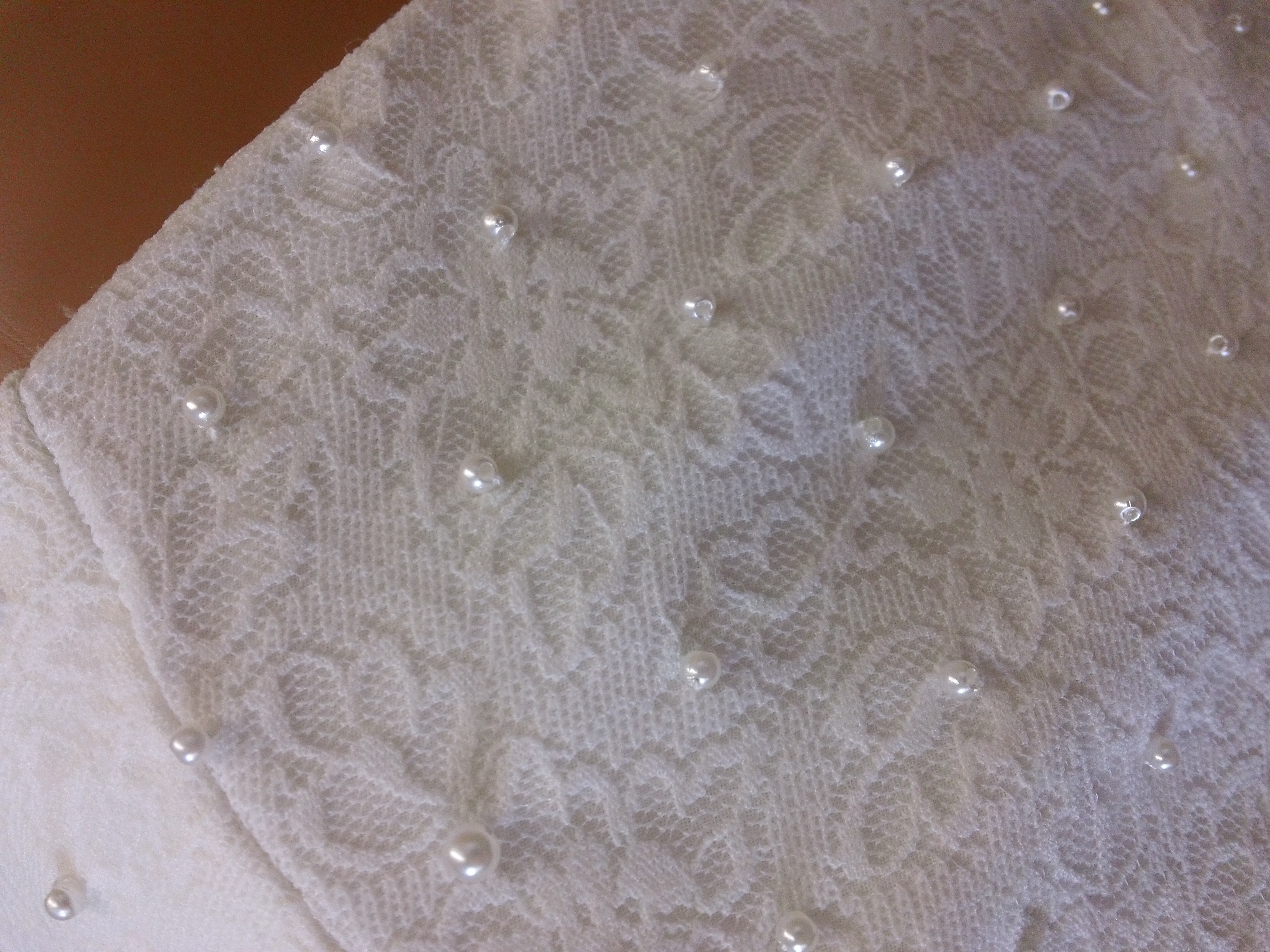 lace bodice is accented with faux pearls