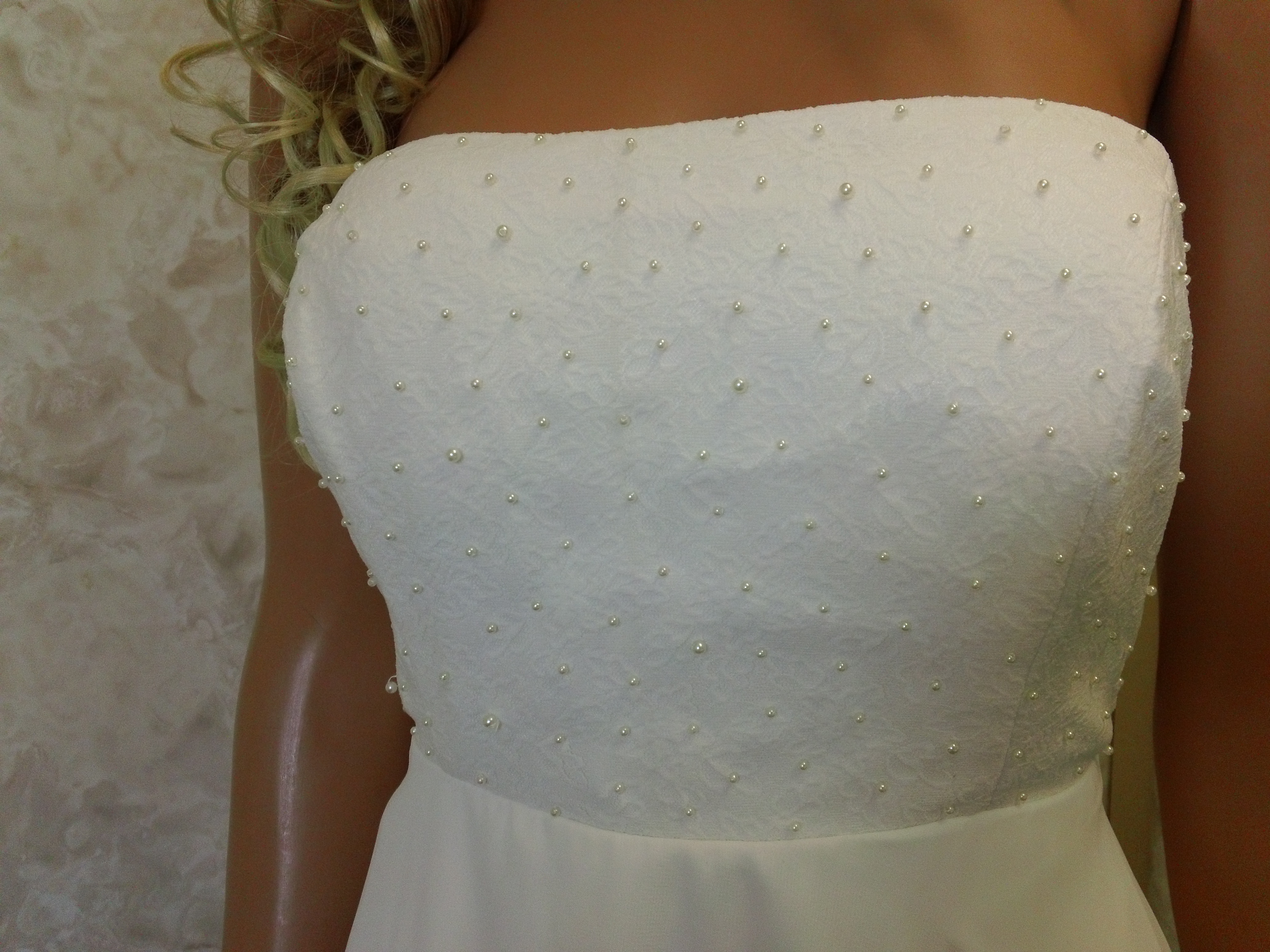 lace bodice is accented with faux pearls