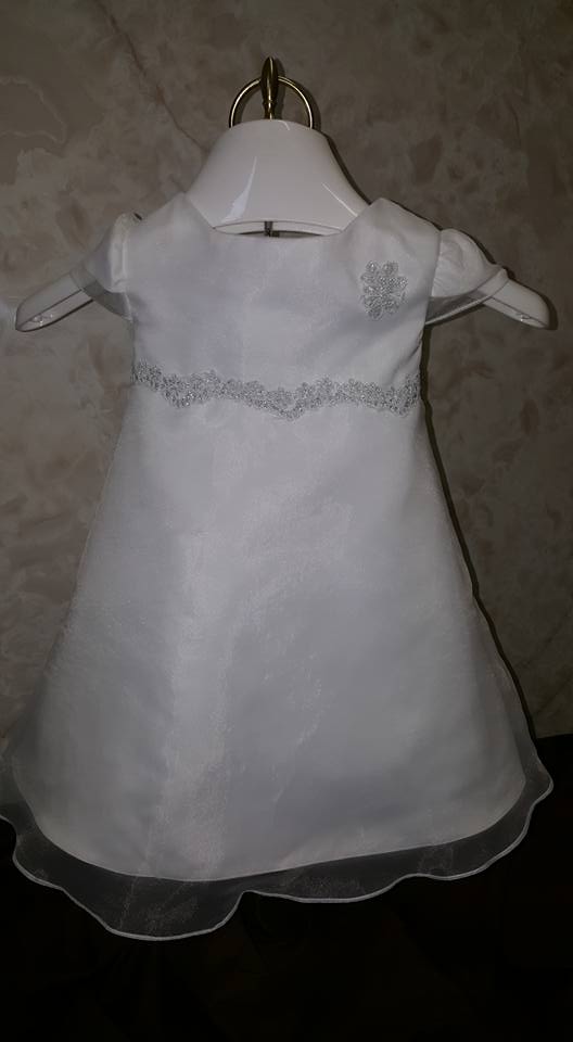 white dress with silver embroidery on sash