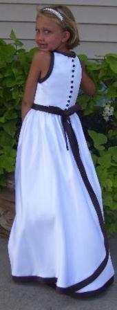 white dress with black ribbon and buttons down the back