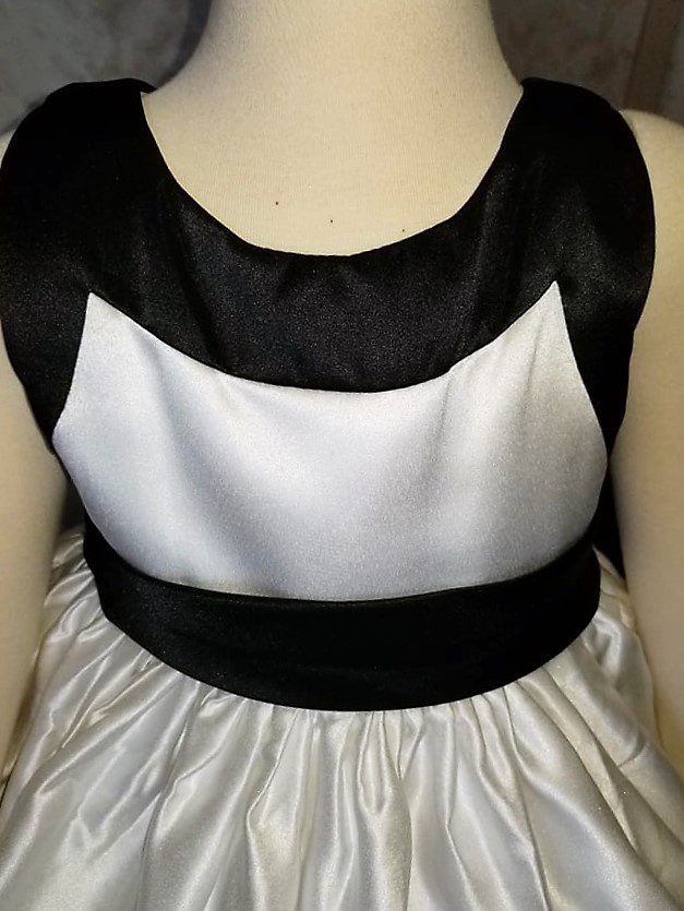 Light ivory and black dress shown in a size 3