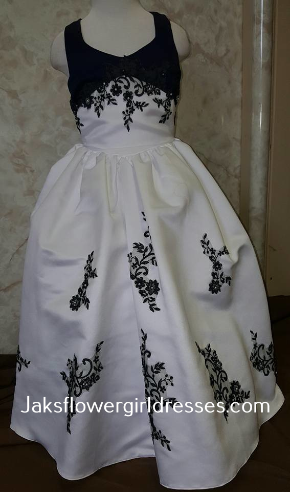 White halter flower girl dress with navy blue appliqués on the bodice and skirt.