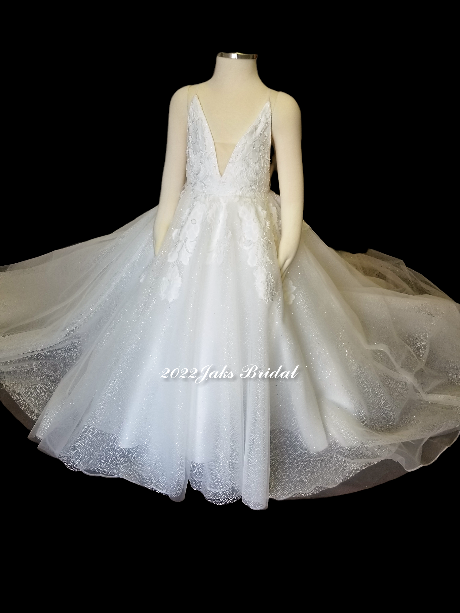 Flower girl dress with plunging neckline, illusion modesty panel, side cut outs, full tulle skirt with lace appliques.