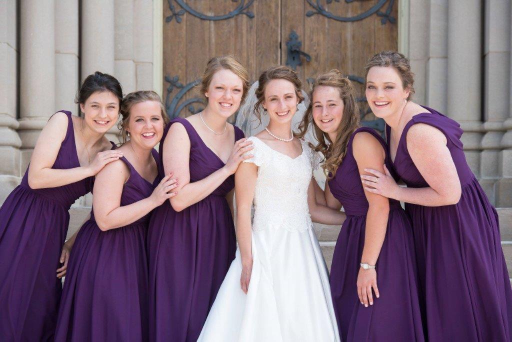 six pretty bridesmaids in purple dresses