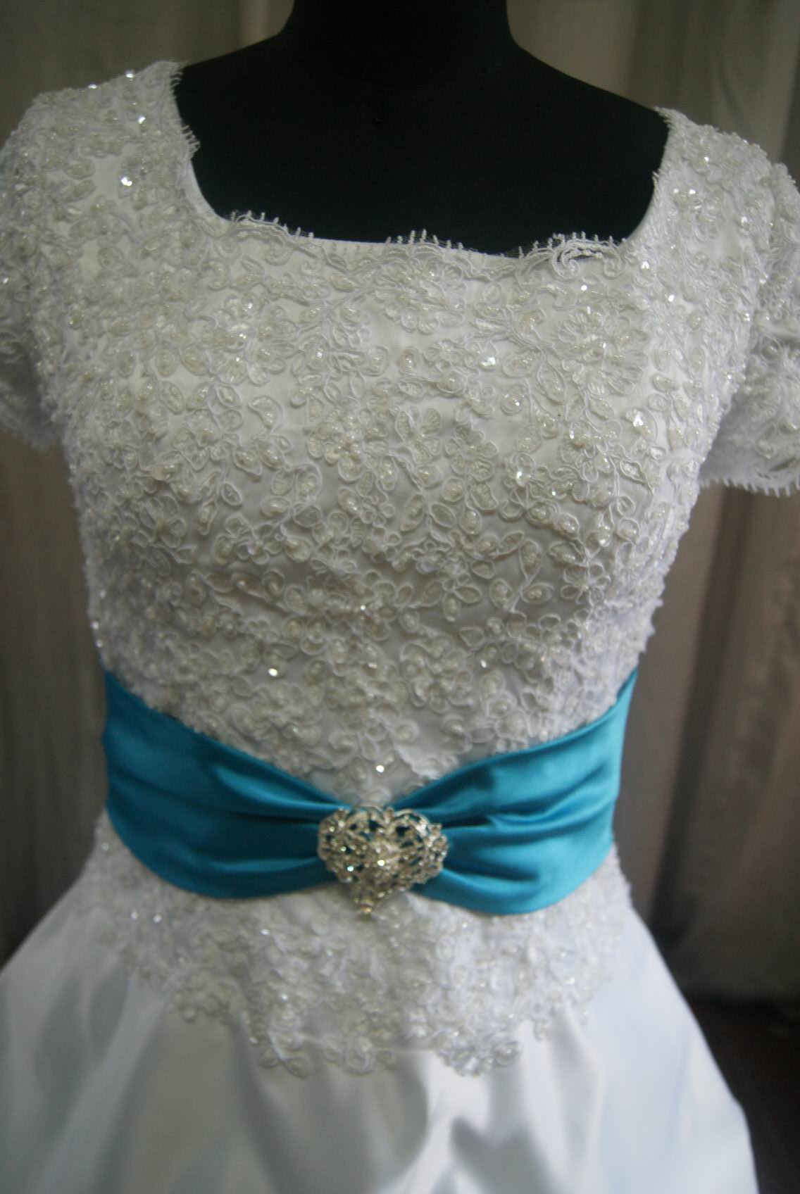lace drop waist dress with turquoise sash
