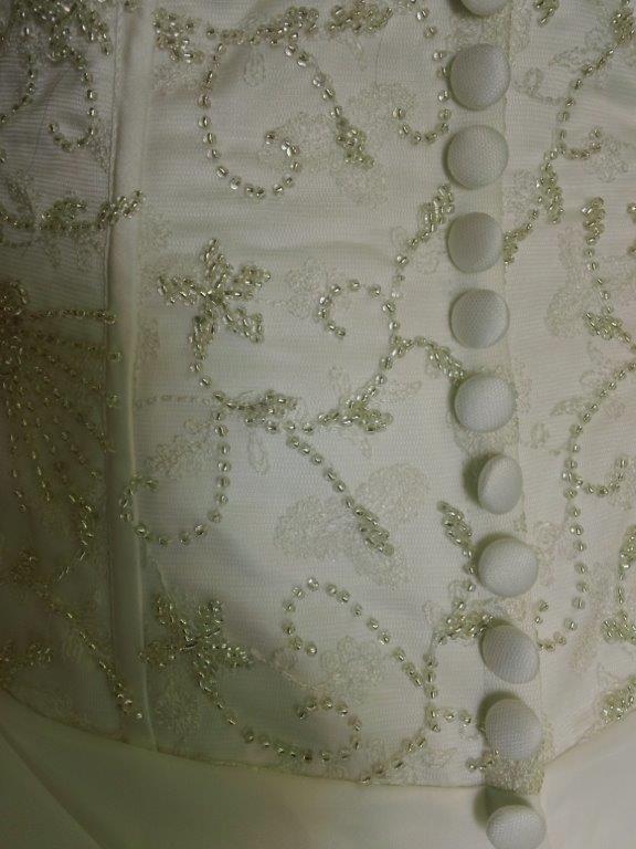 beaded embroidery with covered buttons over zipper