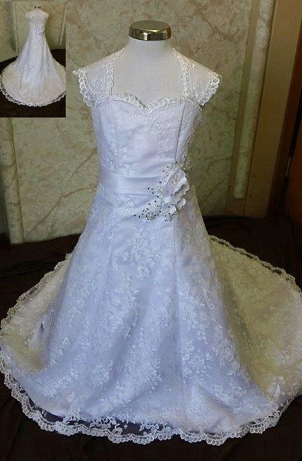 Open back wedding dress and matching flower girl dress with cap sleeves and floral bridal sash