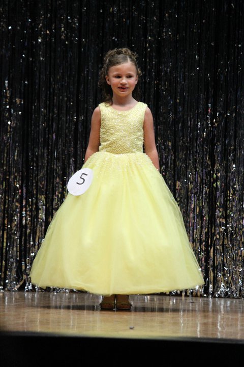 Yellow long sleeveless beaded pageant gown