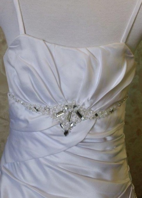 elegant jeweled motif at the empire waist.