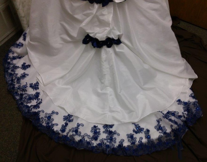 white wedding gown with royal blue roses
