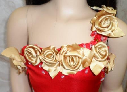 red one shoulder gown with gold rose strap