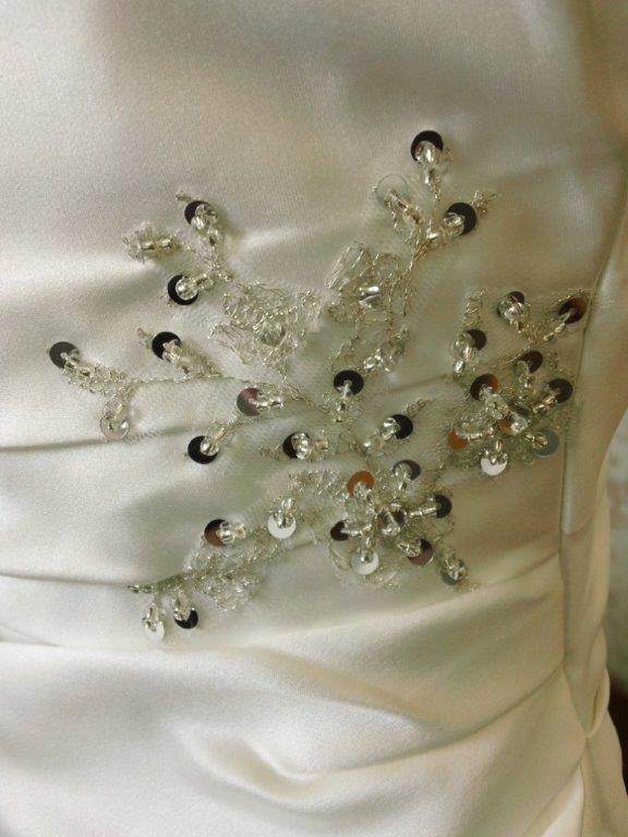 applique and beading at the waist and hip