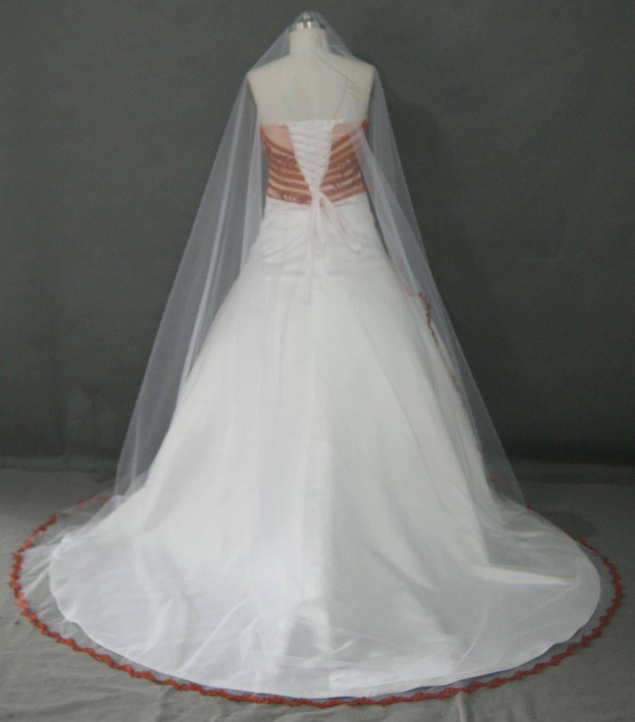 light ivory dress with burnt orange trim and the bride added a matching veil