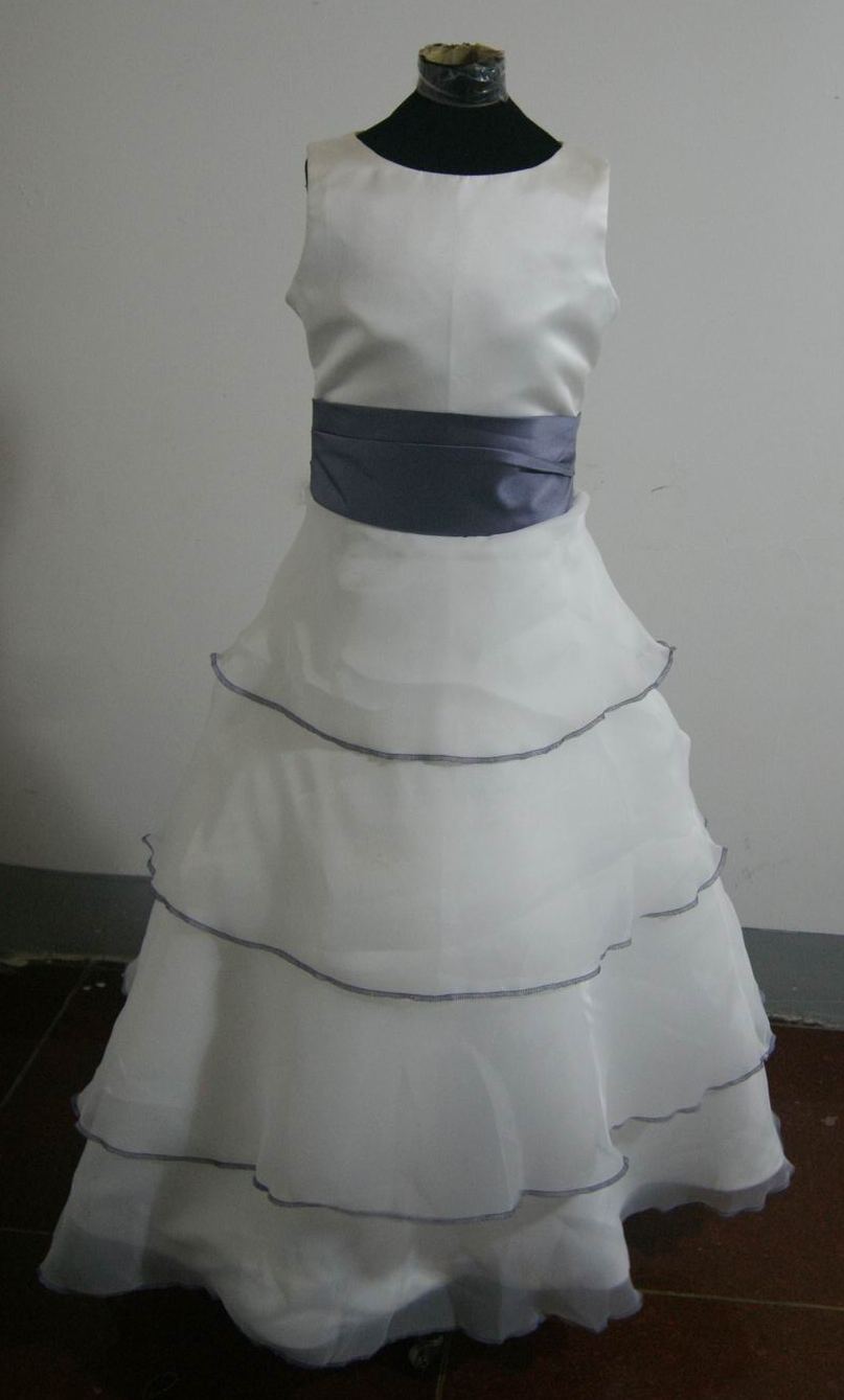 Long sleeveless ivory flower girl dress with 4 tier skirt edged in lilac, and lilac rose sash. In stock & on sale.