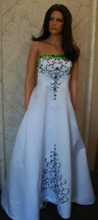 white dress with green trim and black embroidery