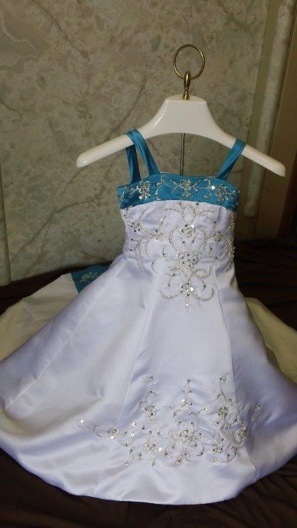 white and turquoise wedding gown with matching infant dress