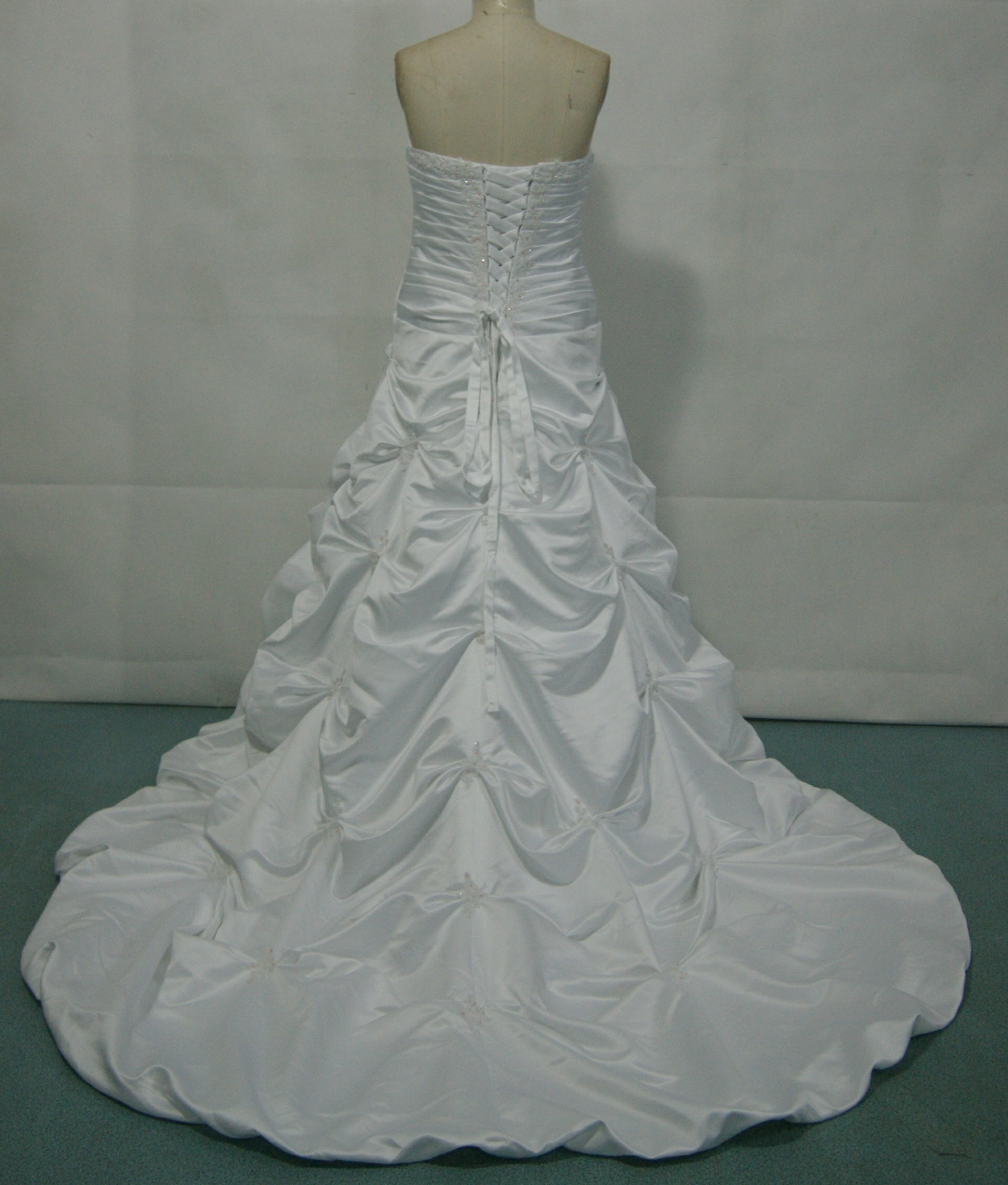 Strapless taffeta gown with asymmetrically draped bodice.