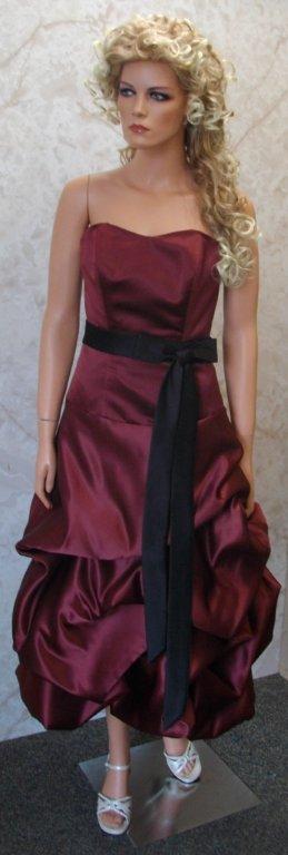 Bridesmaid wearing a merlot tea length dress with black sash