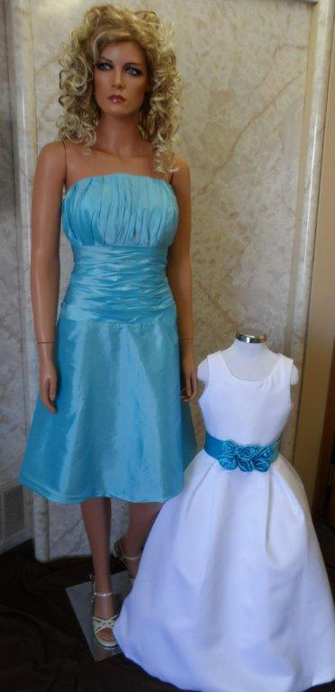 short pool blue bridesmaid dress and matching flower girl sash