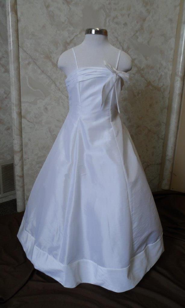 Cheap A-line floor length flower girl dress with full petticoat, spaghetti straps and accent bow.  White or ivory for $40.