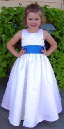 Sleeveless white floor length flower girl dress with blue sash, embroidered bodice.  Size 4 on sale.