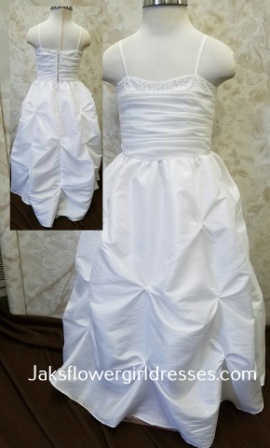 Toddler size long white flower girl dress with beading along top and gathered skirt.