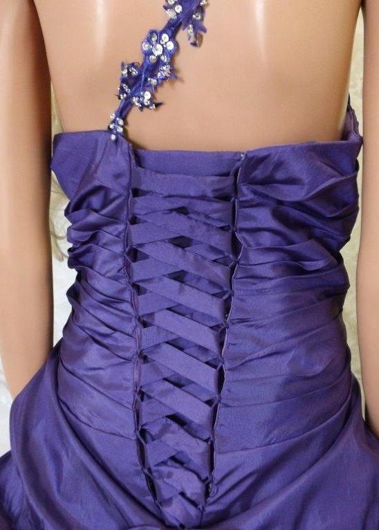 The bodice features one shoulder with sequin appliques
