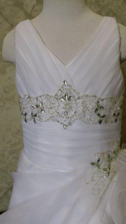 ruched bodice is edged with a jeweled belt