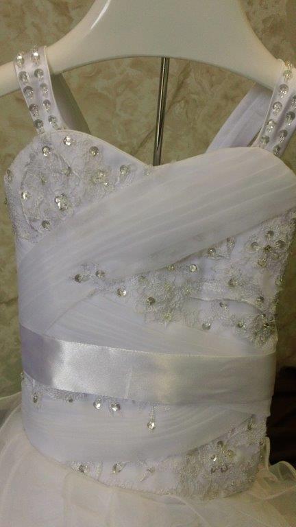 lace appliques across bodice flowing down to the skirt