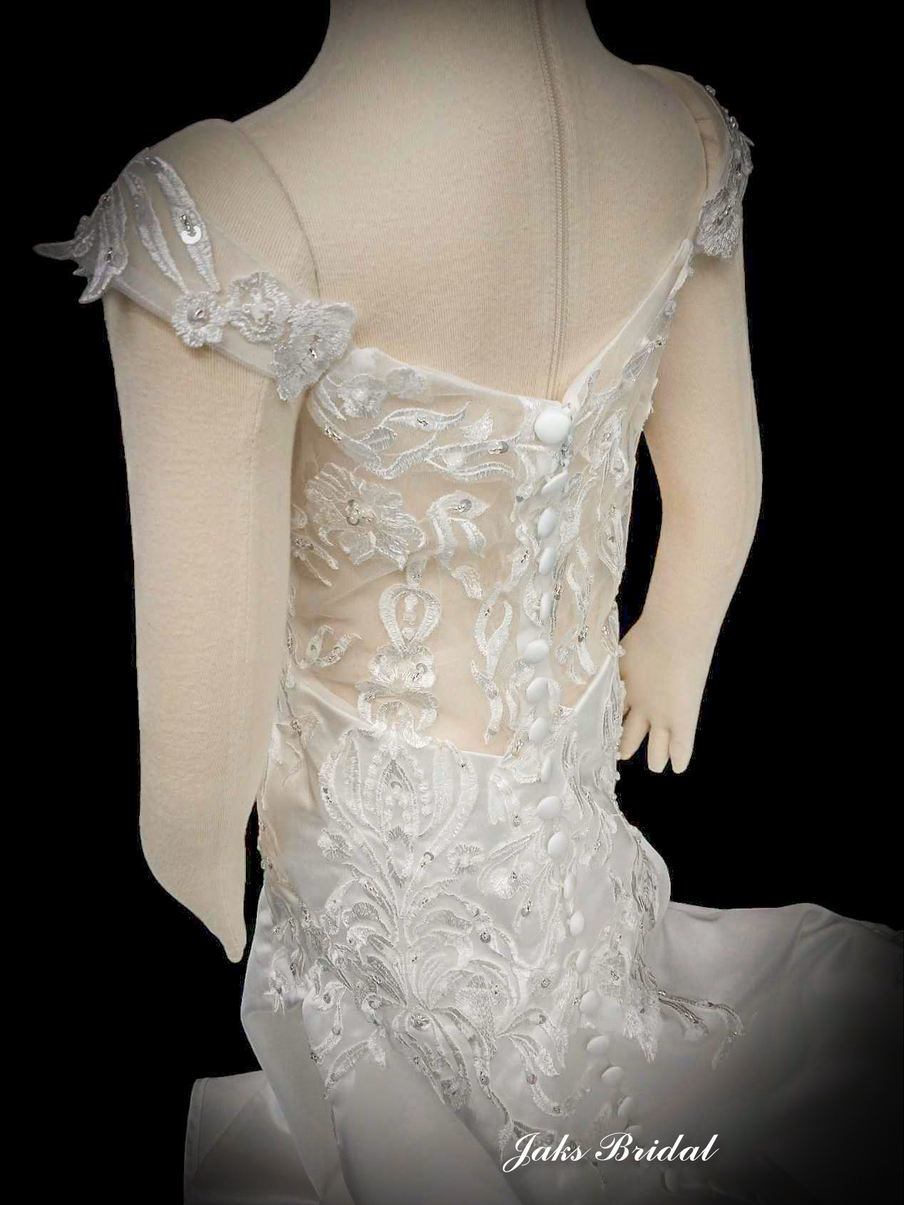 The dress has lace appliqued cap sleeves that sit at your shoulders and lead down to a deep illusion back. 