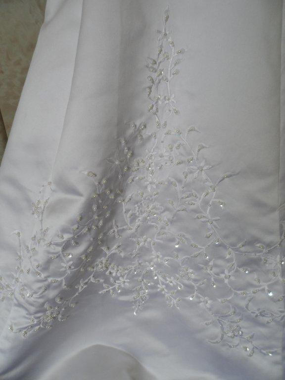 white embroidered skirt of miniature wedding gown