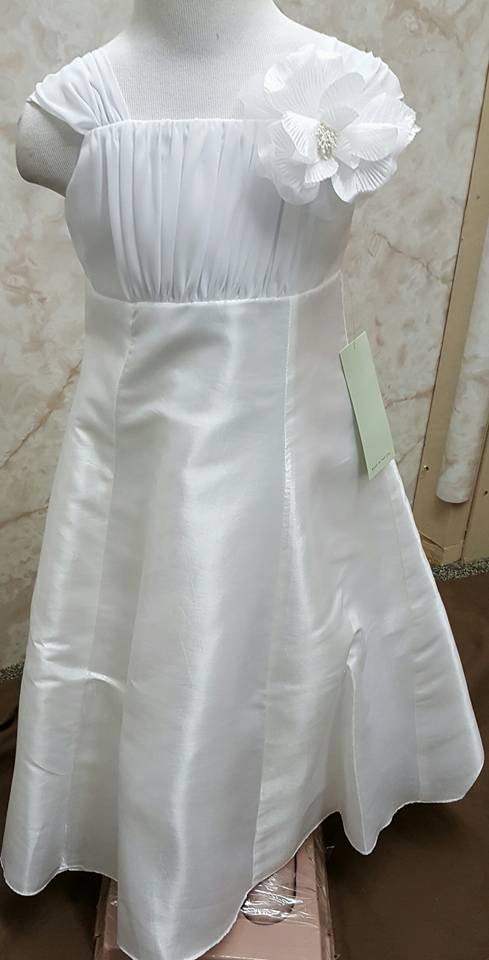 white dress with white flower on the shoulder strap