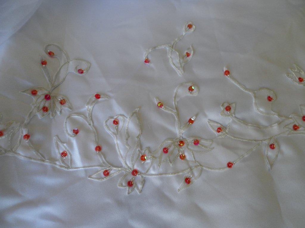 Red beading accent embroidery on train