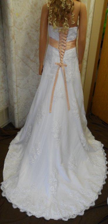 Strapless wedding gown with peach sash and matching corset ties
