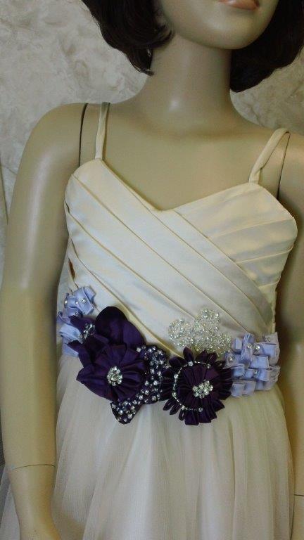 flower girl dress in light champagne with grape and orchid flowers