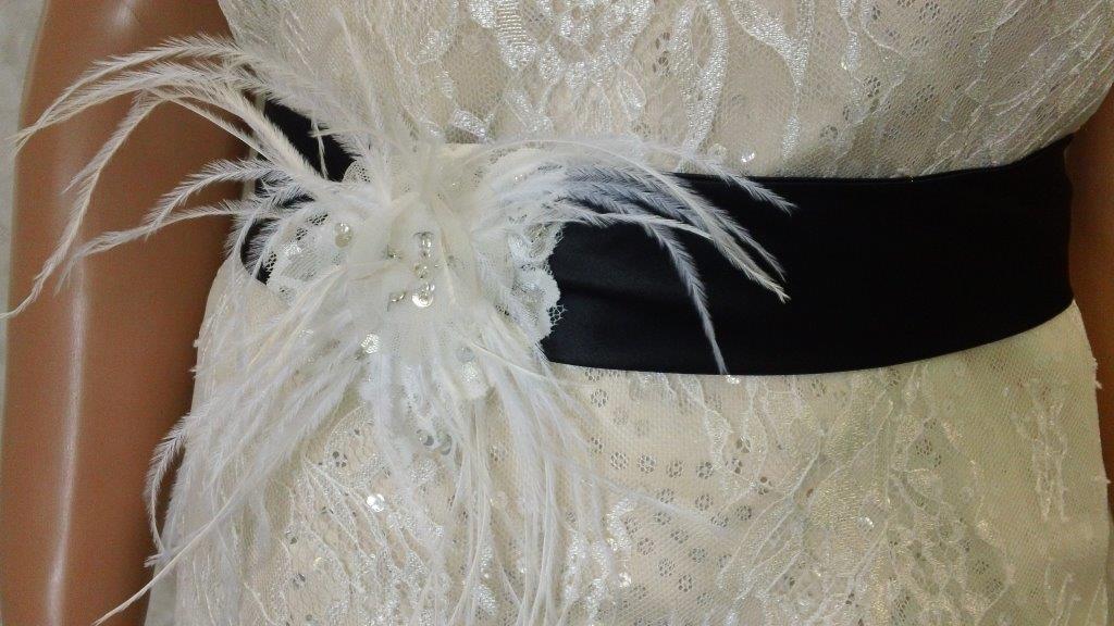 black sash with feather pin