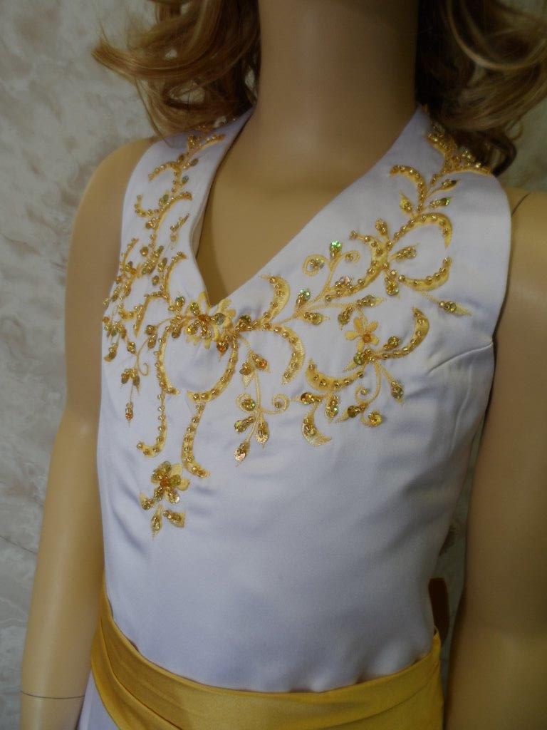 white dress with gold embroidery and sash