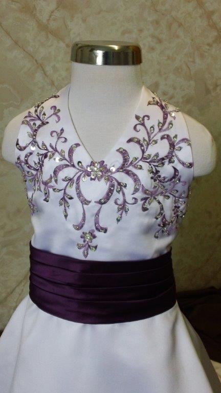 white dress with grape embroidery and sash