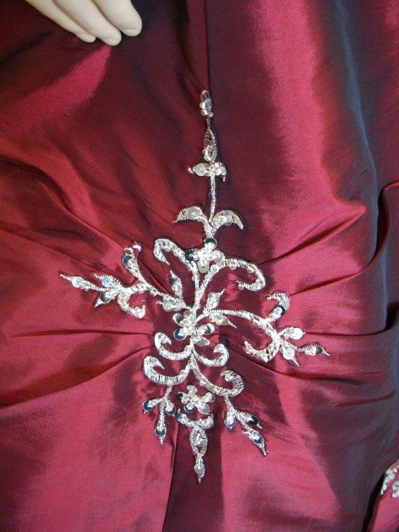 A burgundy halter dress with silver embroidery