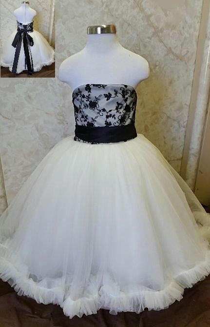 Ivory tulle dress flower girl dress with black lace bodice, and satin sash.  Size 2 floor length ball gown with ruffle hem. 