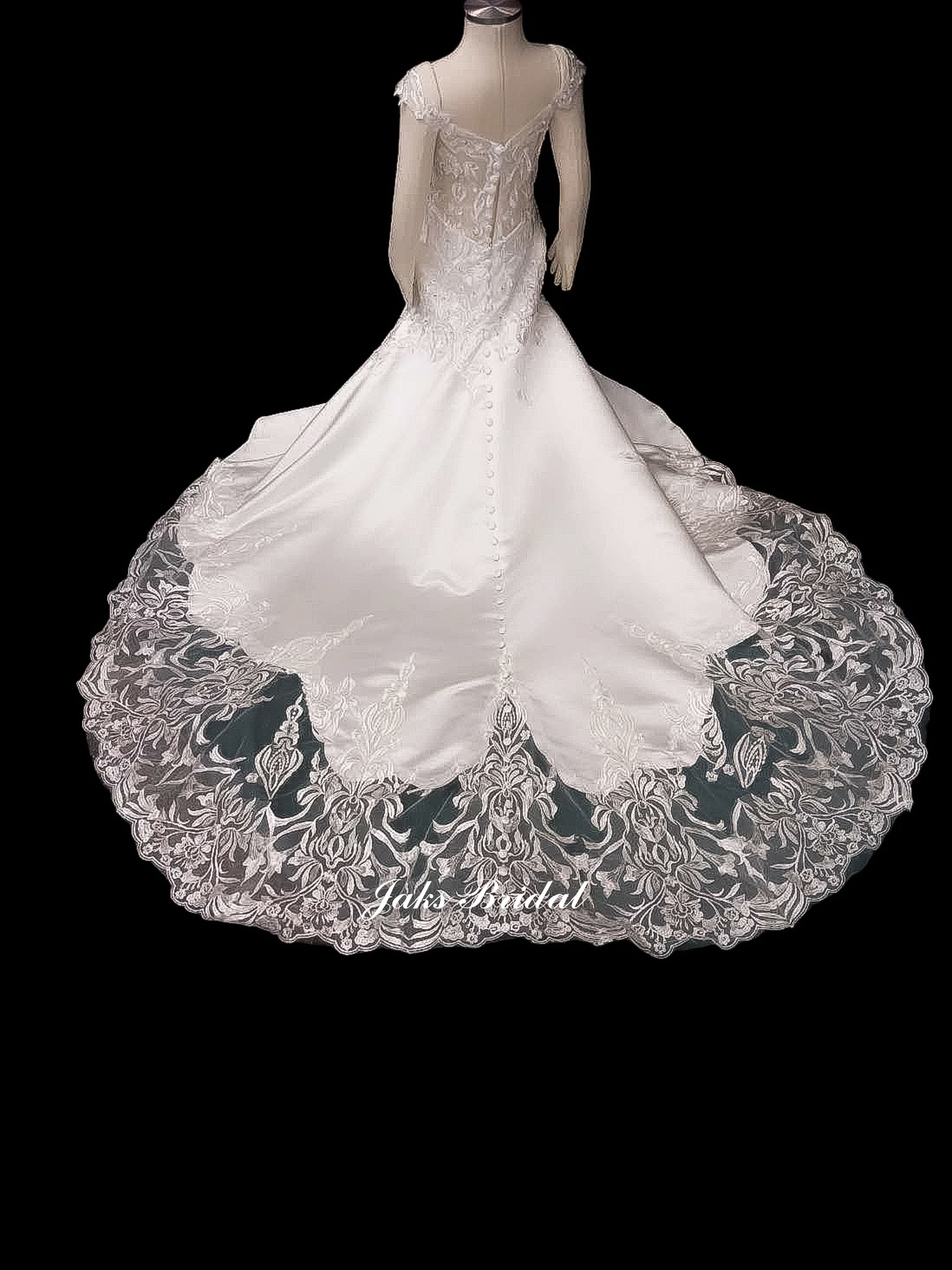 This mermaid dress has a plunging neckline with an illusion lace back. The cathedral train is adorned with lace appliques that match the bodice.