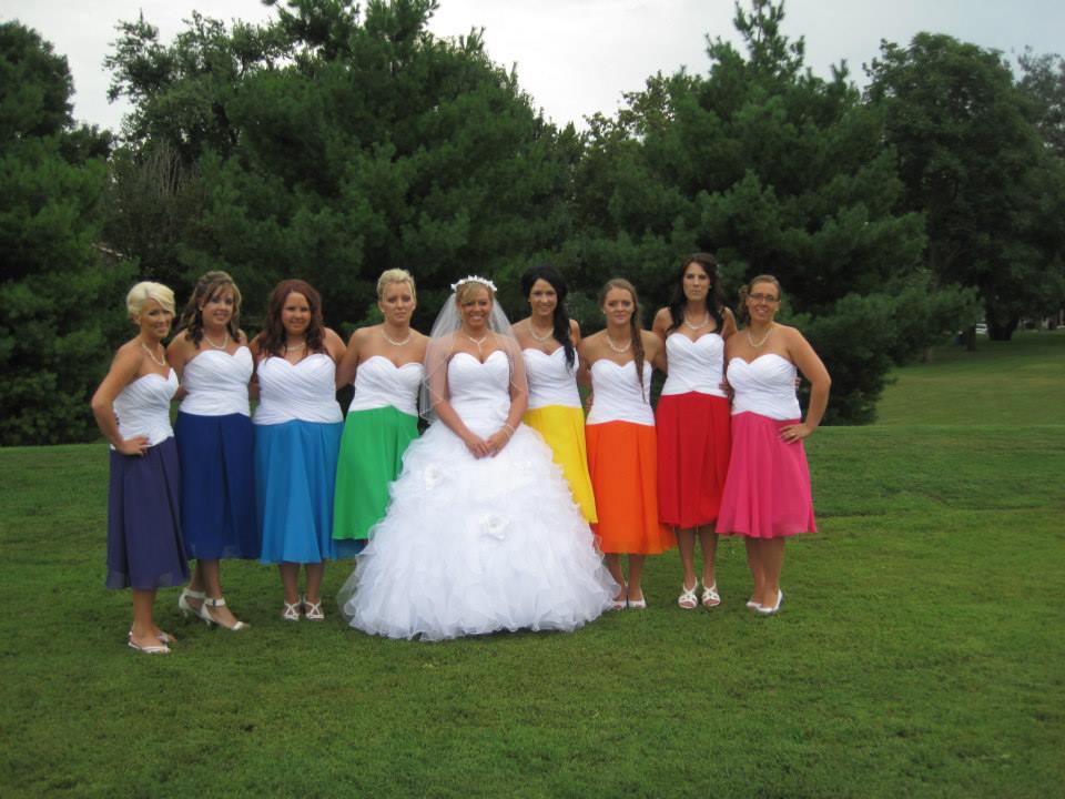 8 bridesmaids in short rainbow colored dresses